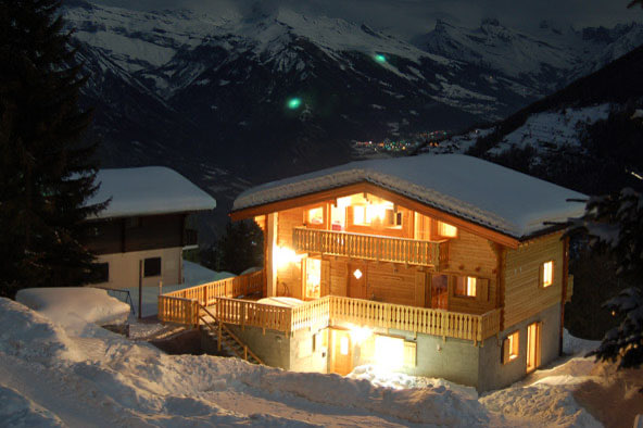 Chalet Charmille lit up at night in the snow